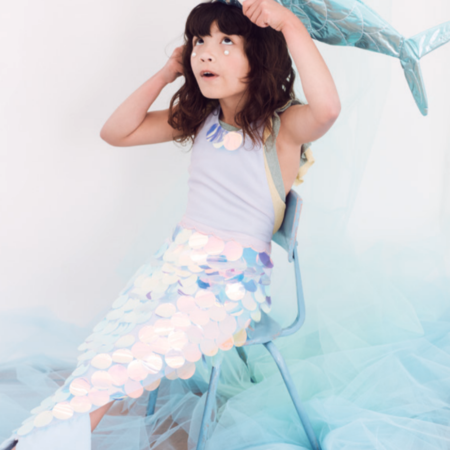 girl sitting wearing mermaid outfit