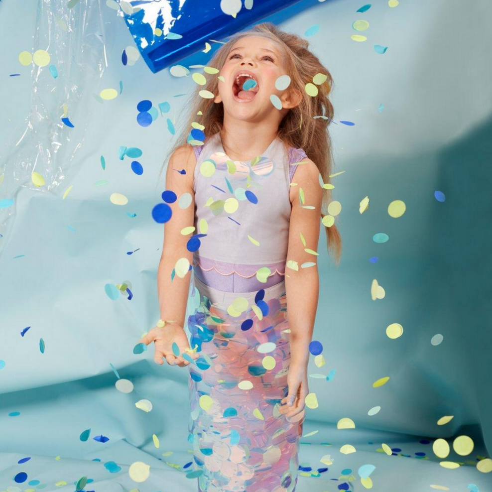 girl in mermaid costume covered in confetti