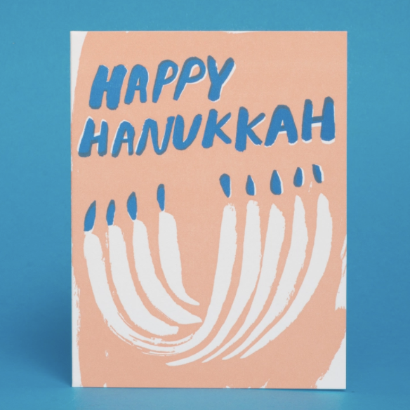 pink card with menorah that reads "Happy Hanukka" on blue background