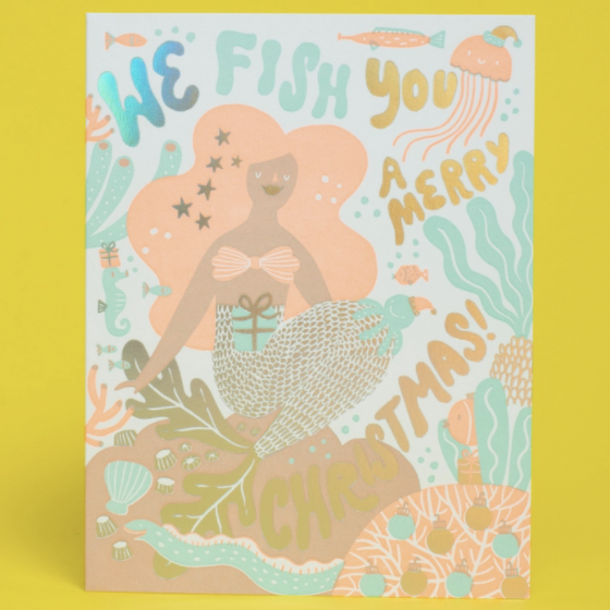 mermaid card with "we fish you a merry Christmas" written on it on yellow background