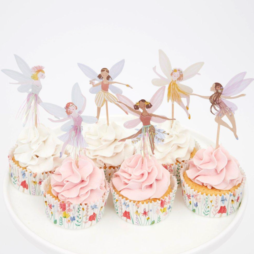 cupcakes with fairy toppers in them