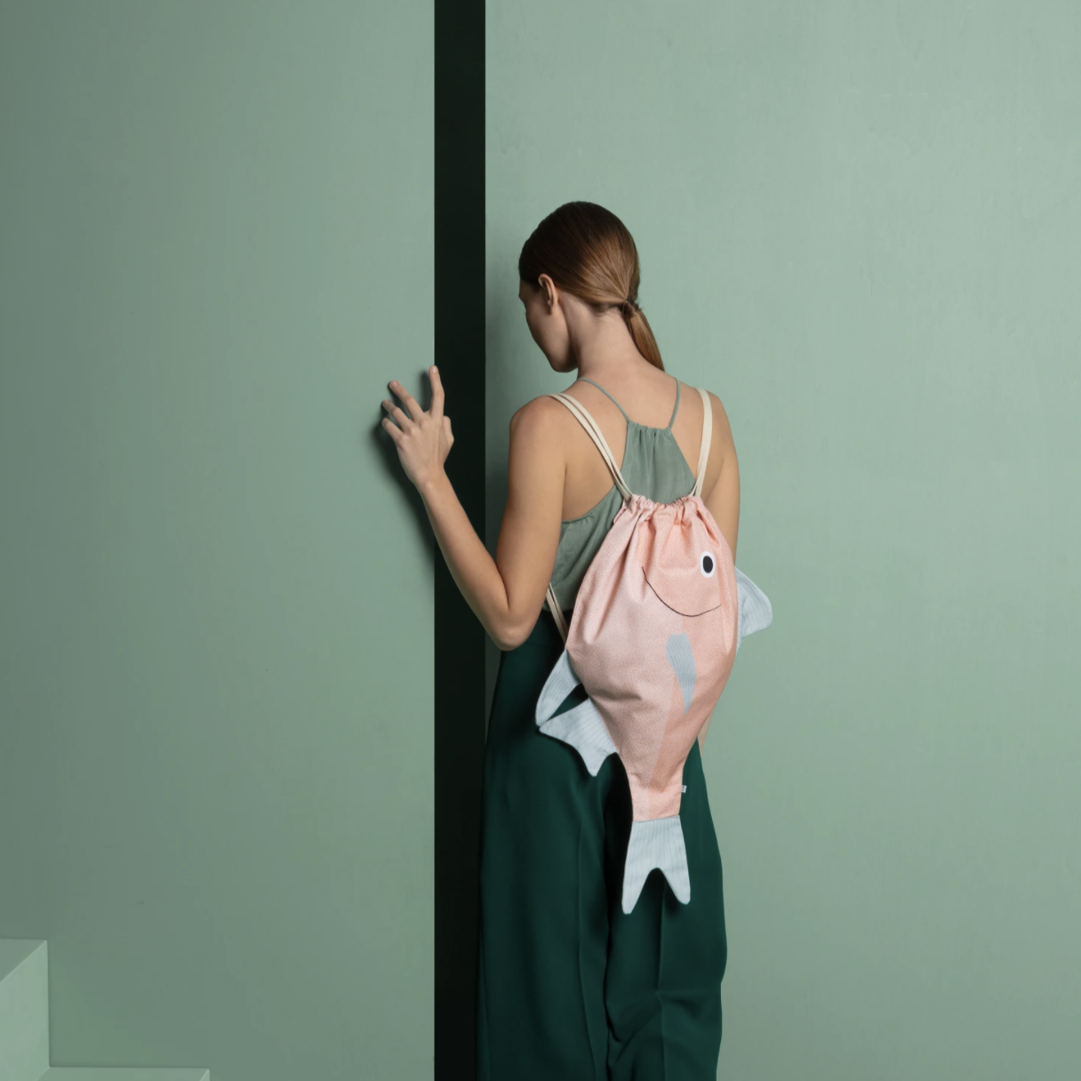 woman wearing fish shaped backpack