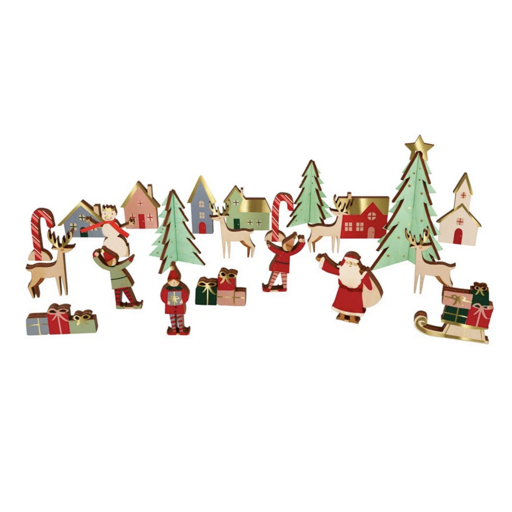 A series of wooden advent calendar figures including Santa, reindeer, a snowman, a sledge with gifts, and a Christmas tree, all in a festive village scene.