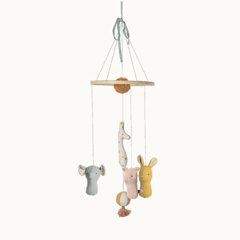 A mobile with plush animal toys in soft colors with a wooden ring for hanging.