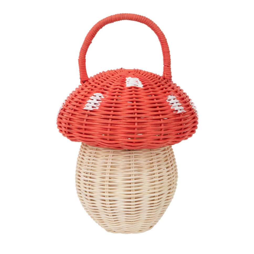 A wicker basket designed to resemble a mushroom with a red cap and white spots, featuring a wooden bead closure at the top.