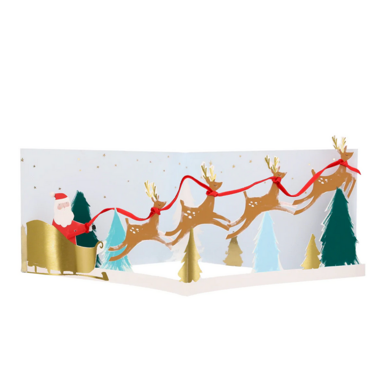 A 3D Christmas card featuring Santa Claus in a sleigh pulled by reindeer, with gold foil details, red velvet ribbon, and white pompom embellishments.