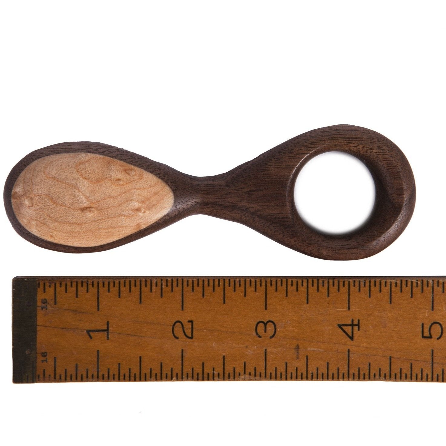 wooden rattle next to ruler showing 5"