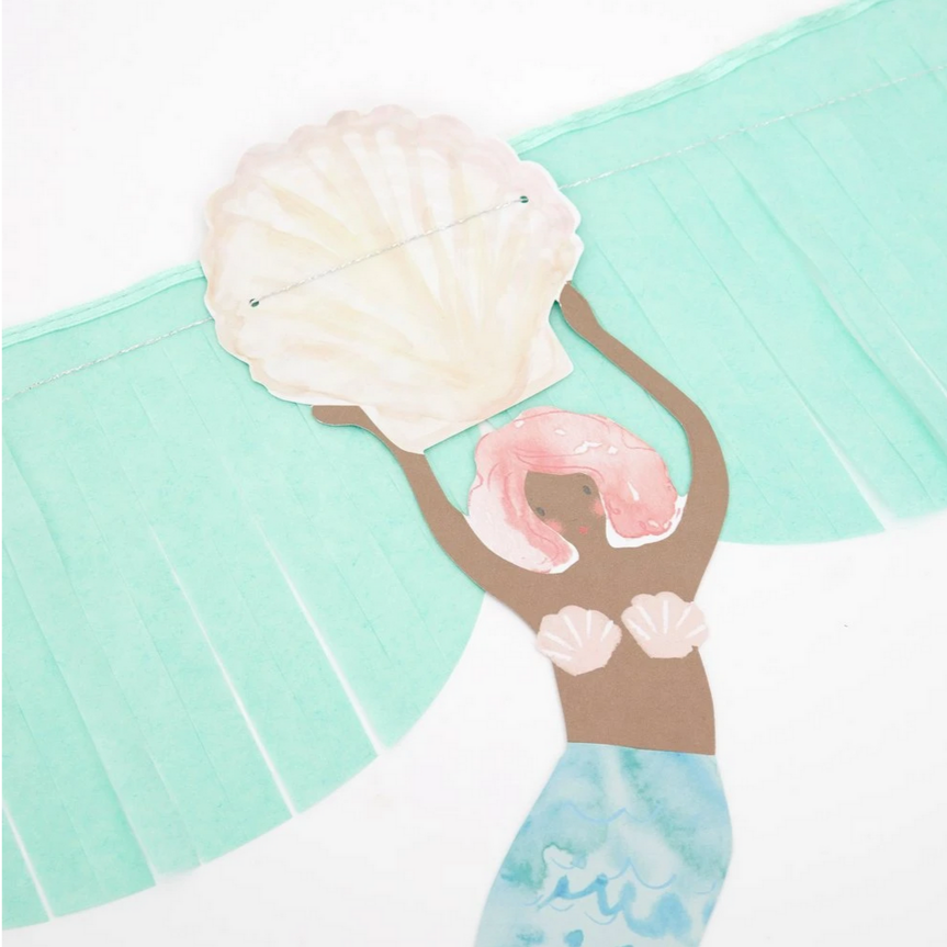 close up of dark skinned mermaid with blue tail