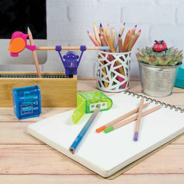 blue and green sharpeners on a desk with pencils