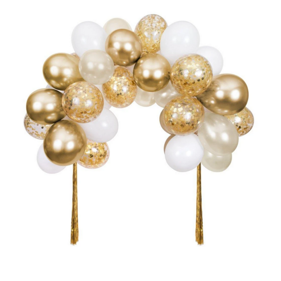 A gold balloon arch kit with a mix of solid gold and gold confetti balloons, arranged in an arch shape with tassels on the ends.