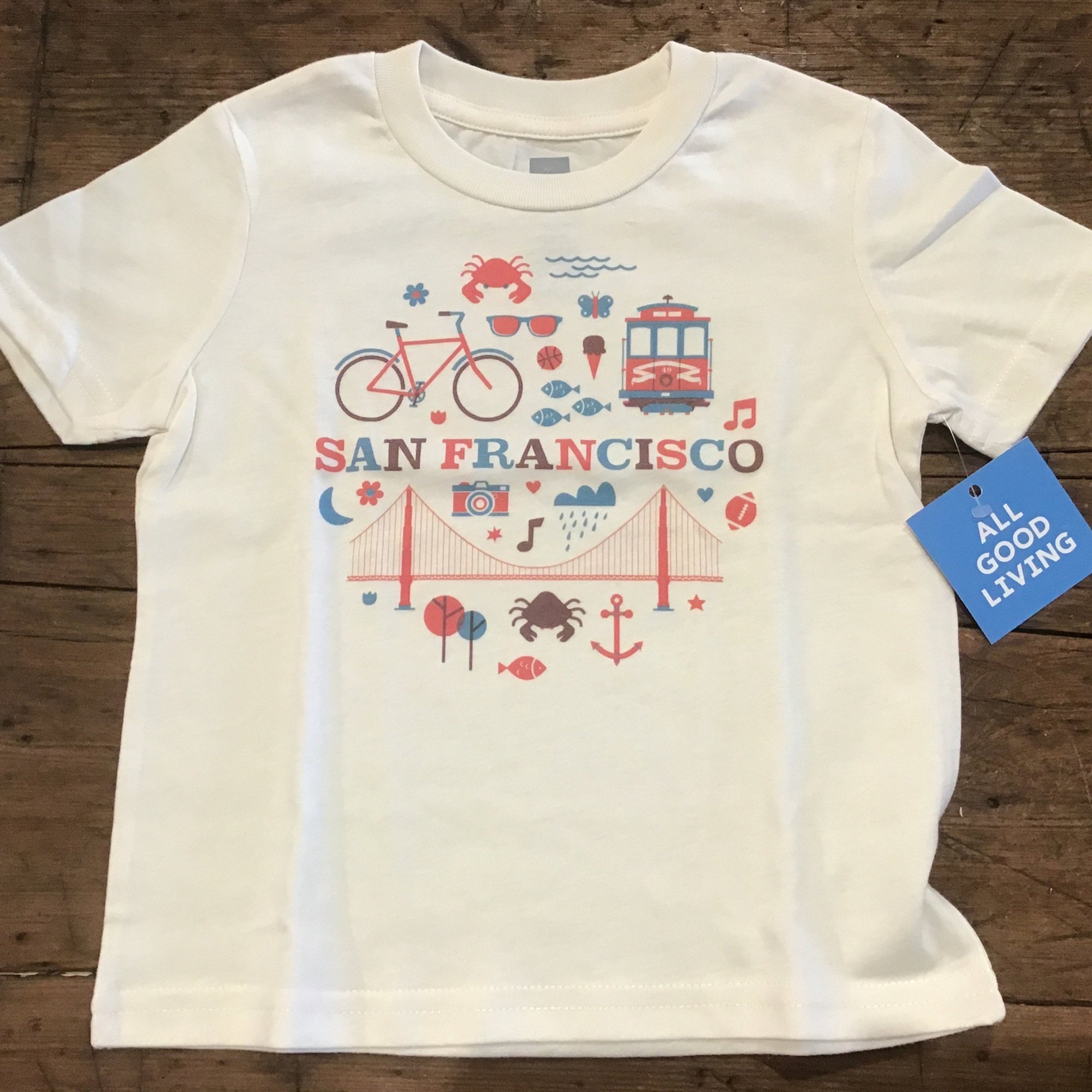iconic pictures of San Francisco on cream shirt. Golden Gate Bridge, Cable car, bike ect.