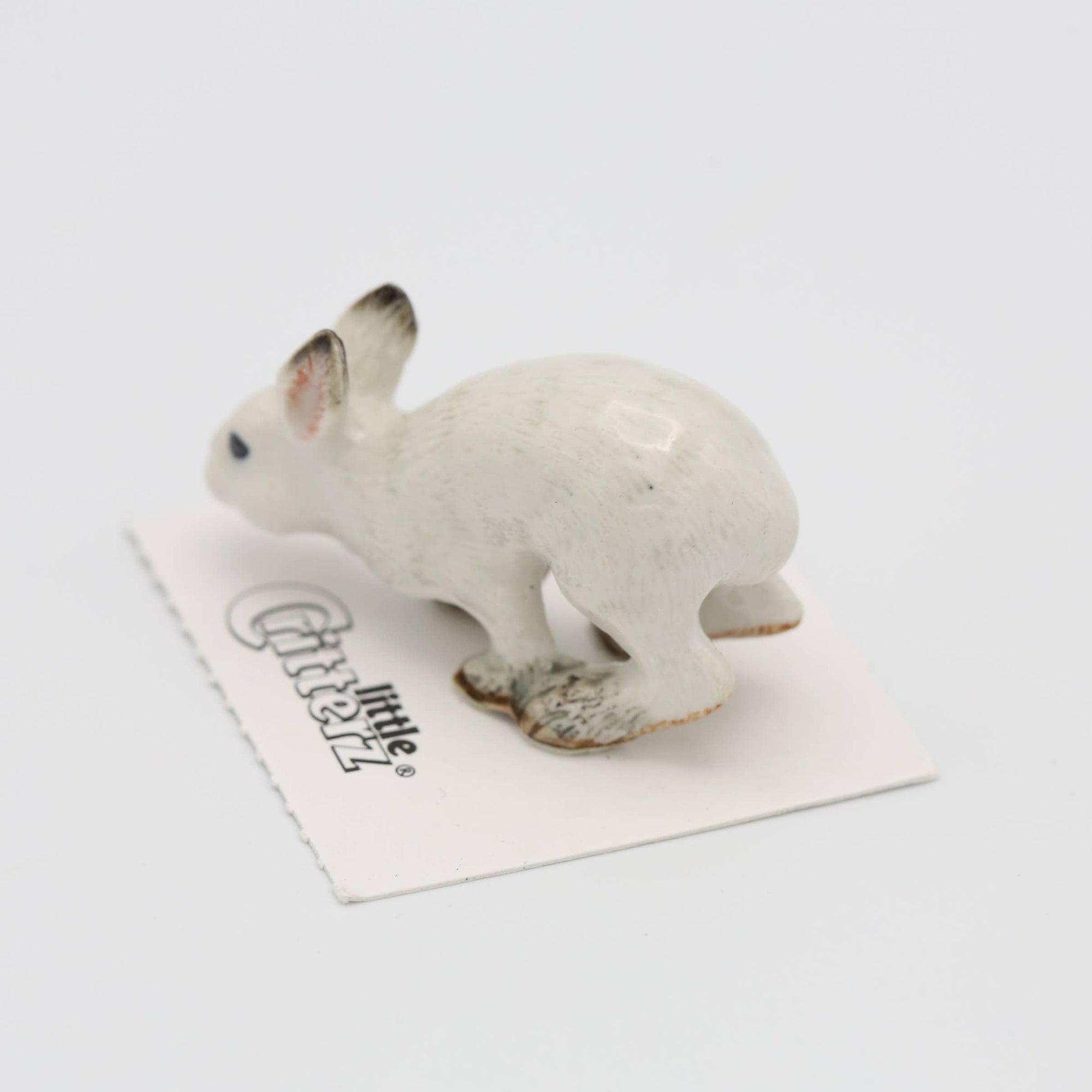 White ceramic rabbit figurine on a white background
