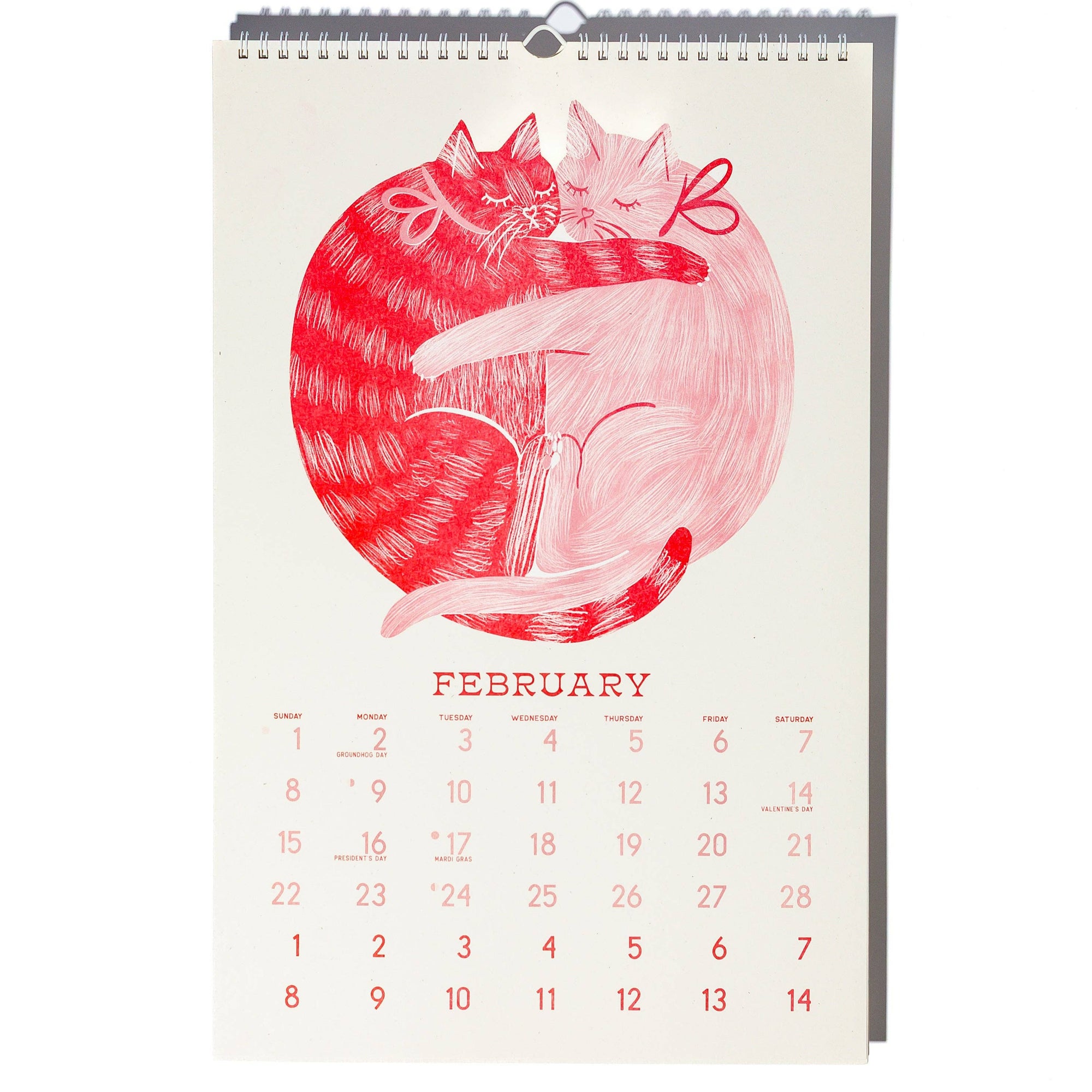 Calendar with a red and white illustration of two cats hugging, set against a white background.