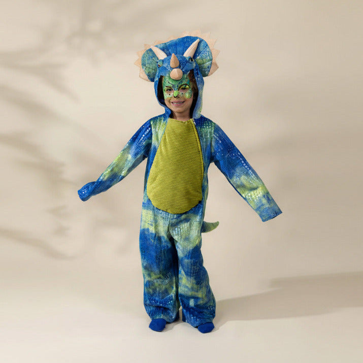A child wearing a blue and green dinosaur costume with a hood featuring large horns and ears, standing against a plain light beige background.