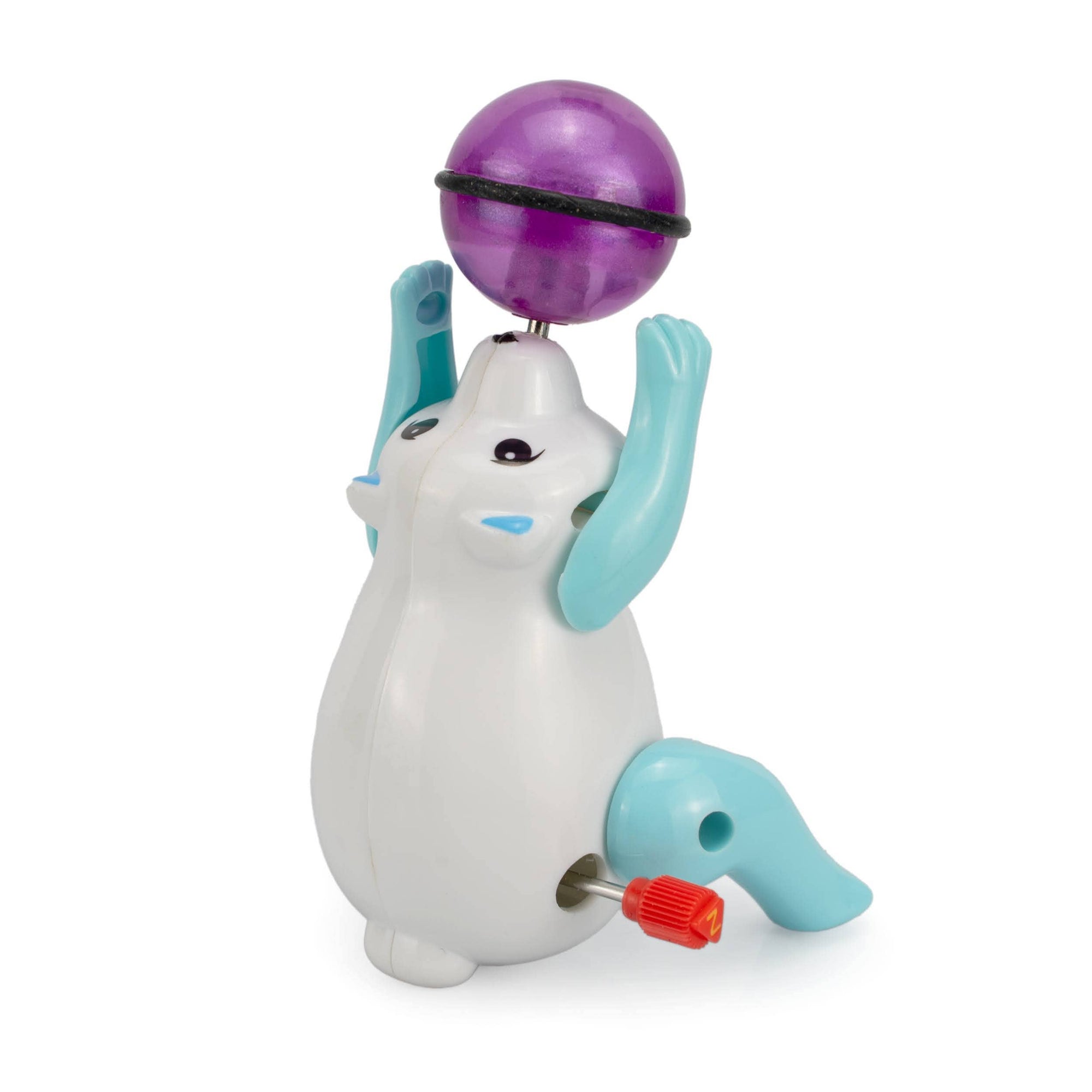 Toy figure of a white creature with blue arms and legs, holding a purple ball on a white background