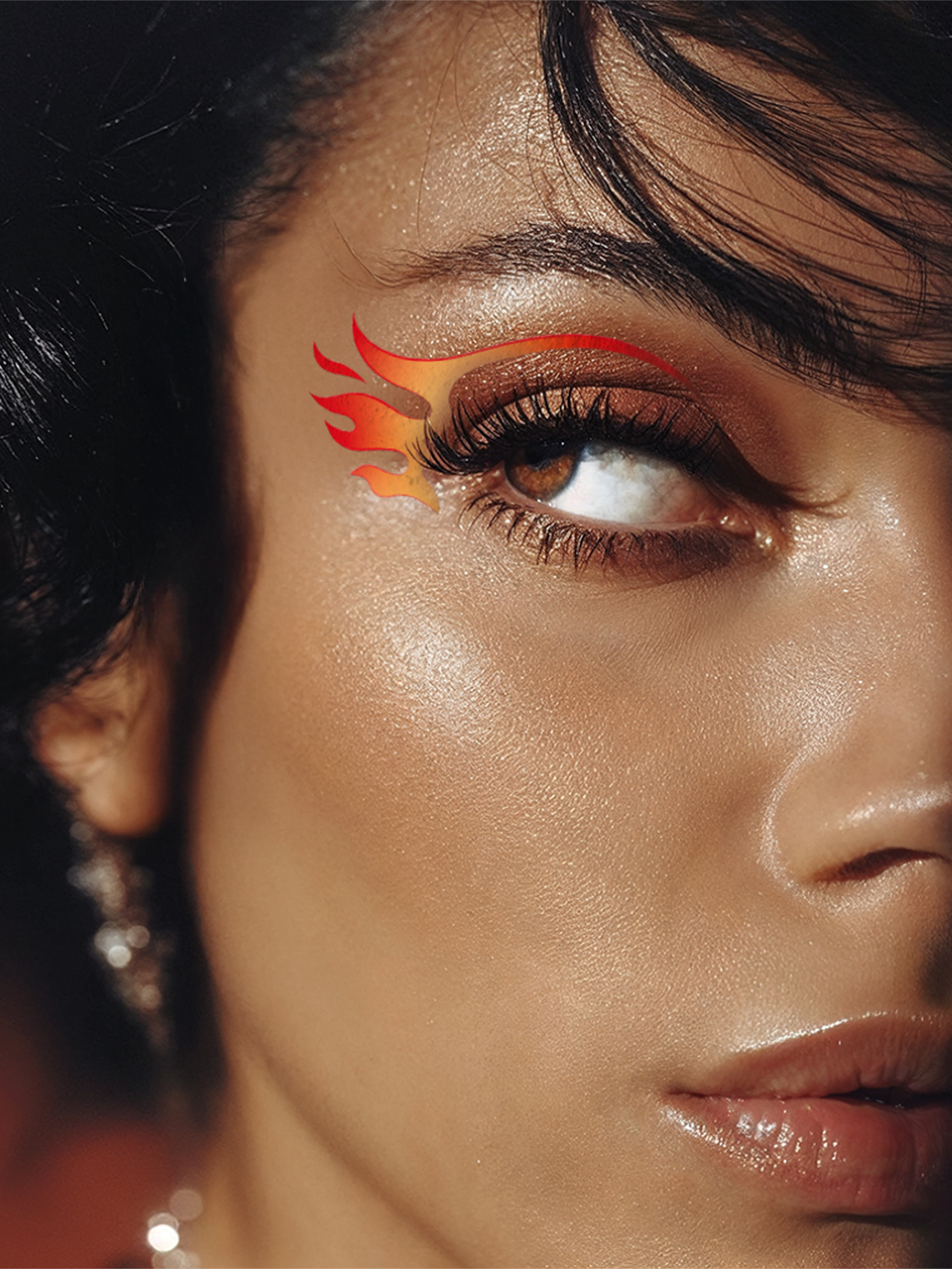 Close-up of a woman's eye with flame-shaped makeup