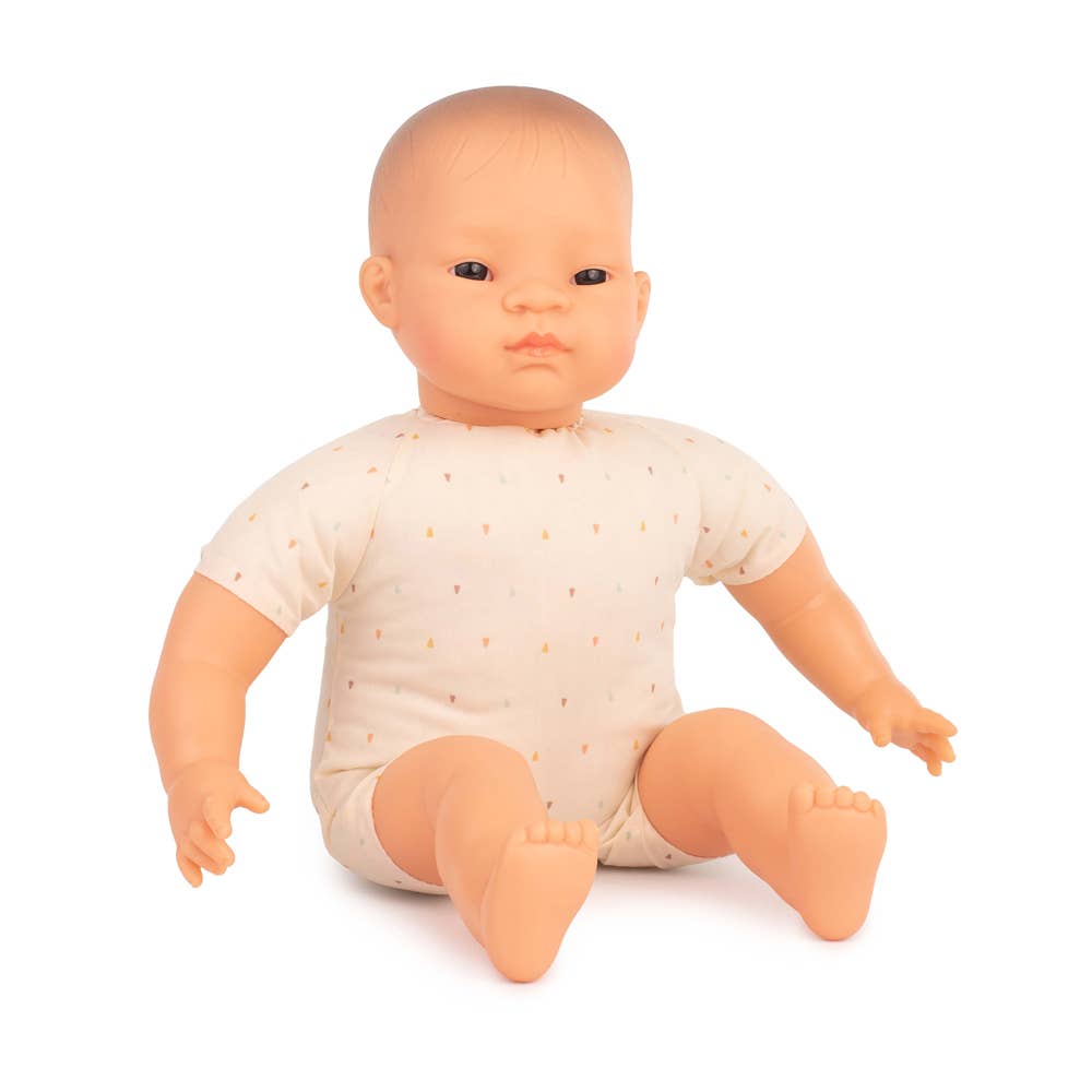 Baby doll wearing a beige onesie on a white background