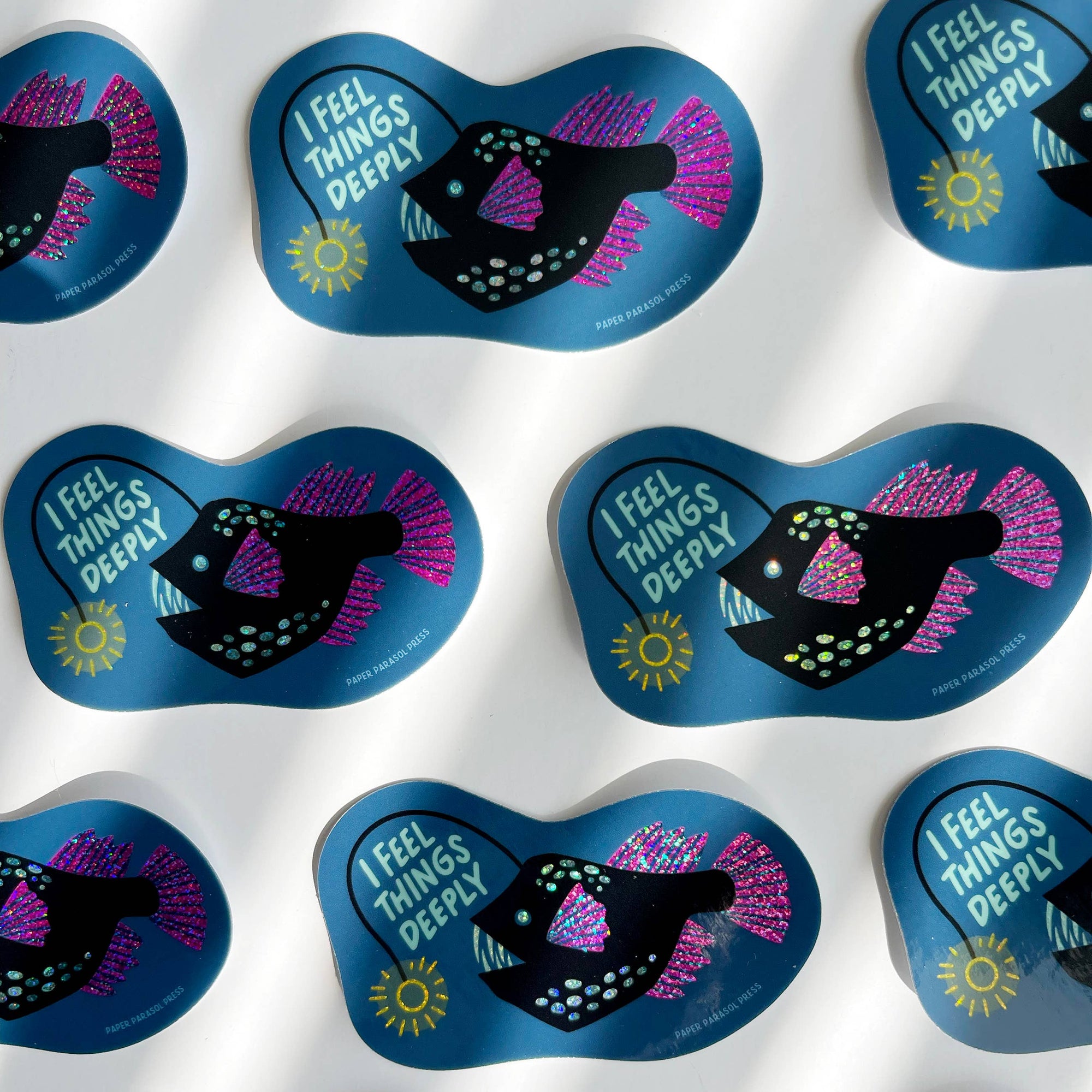 Stickers with fish design and 'I Feel Things Deeply' text on a white background