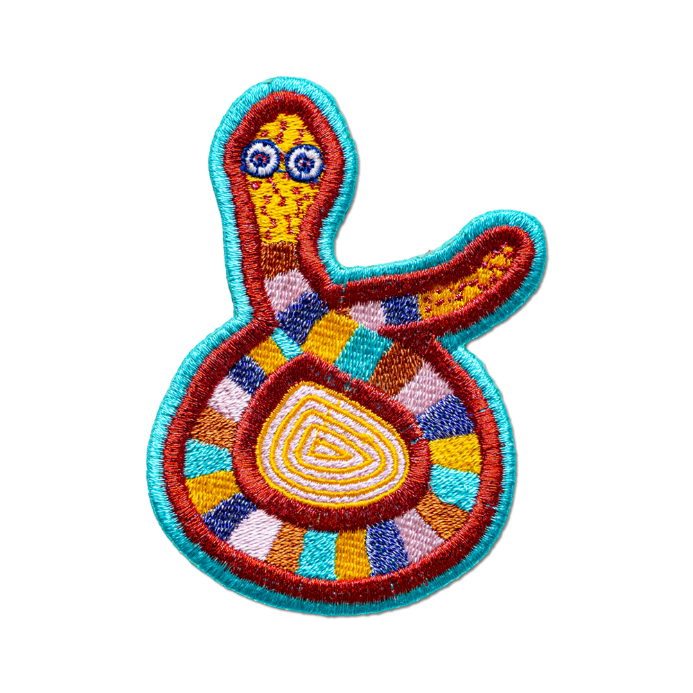 Colorful embroidered patch of a stylized creature on a white background