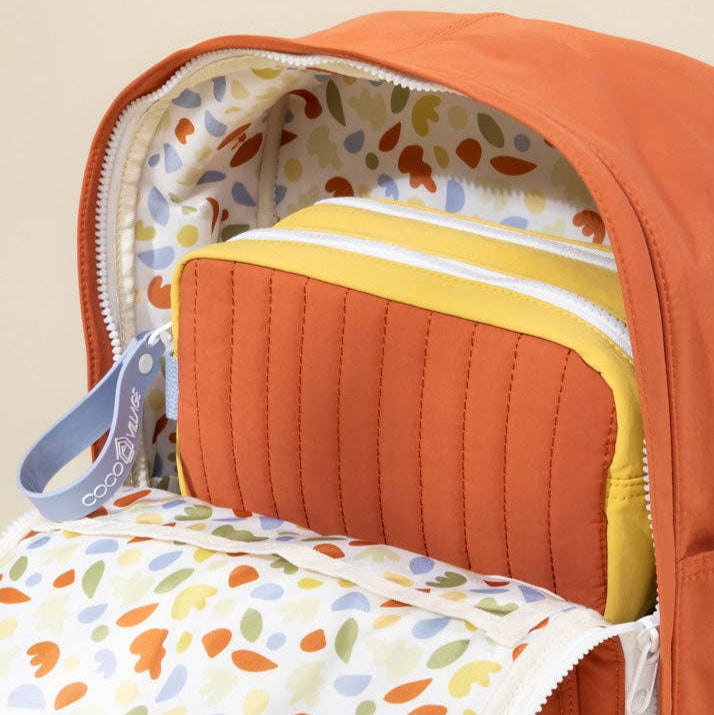 Orange backpack carrier with colorful lining and a smaller pouch inside.