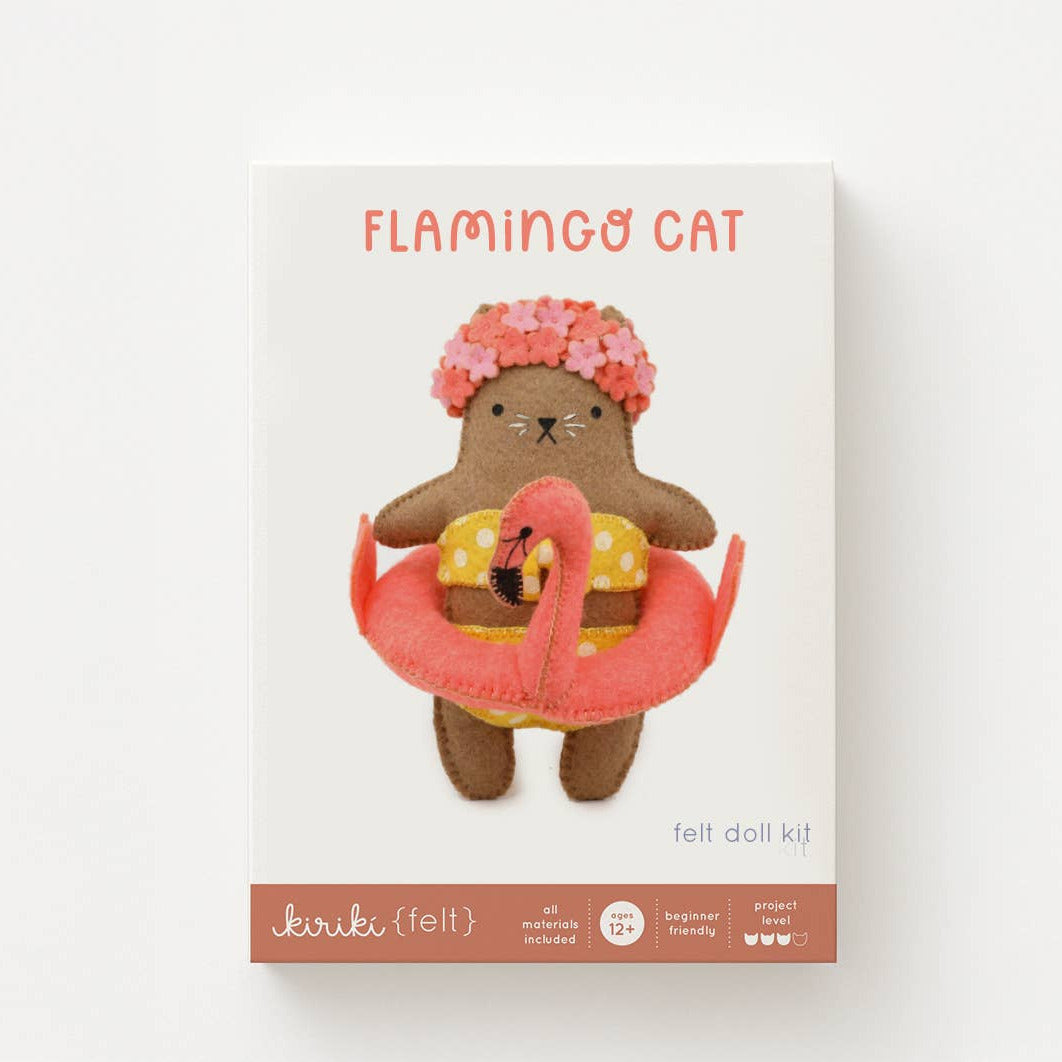 Felt doll kit packaging with a brown bear-like character wearing a swimsuit and flamingo float, on a white background.