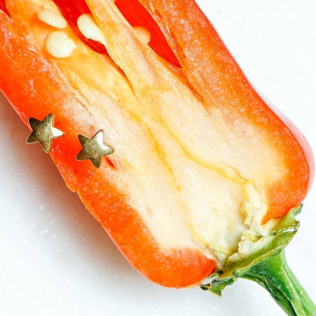 Halved red chili pepper on a white background
