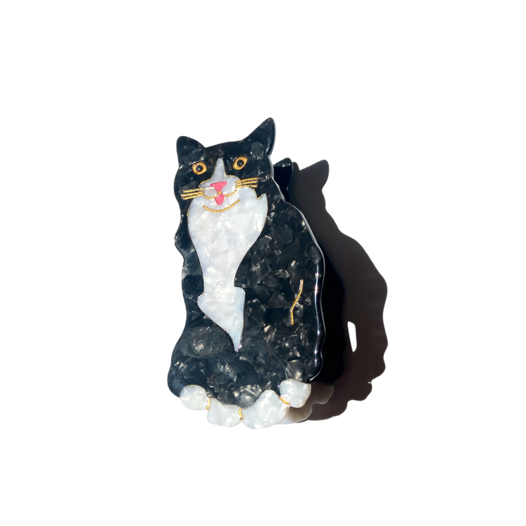 Black and white cat figurine on a white background