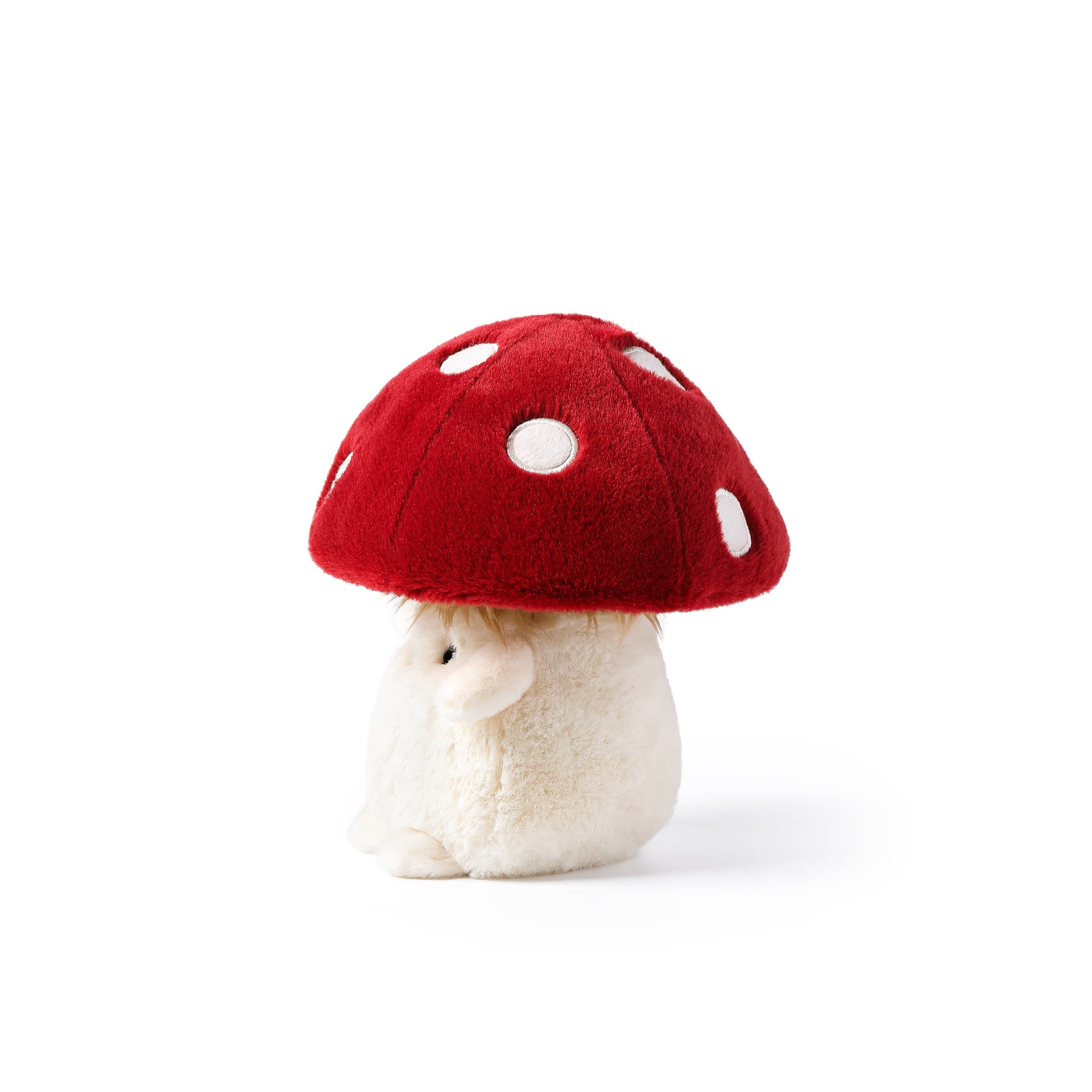 Small plush toy with a red mushroom cap on a white background