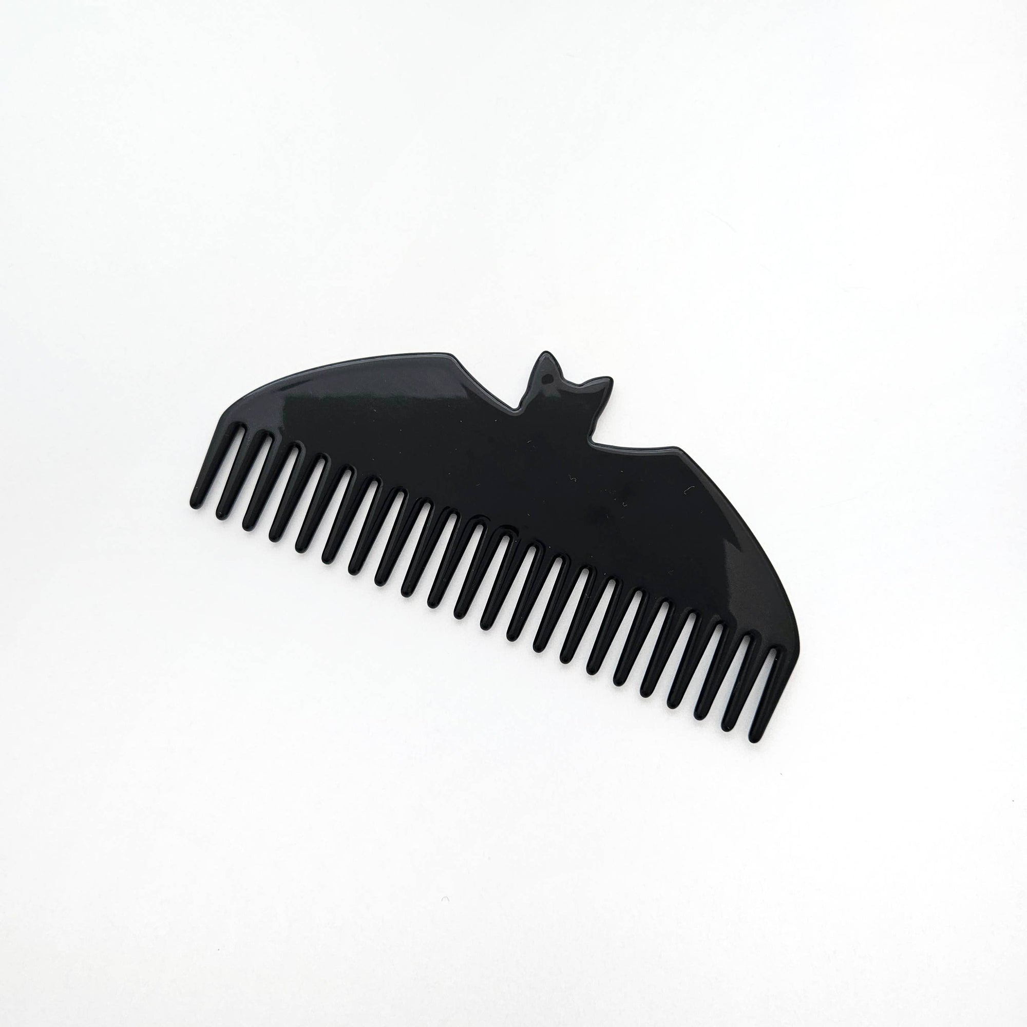 Black comb with a bat design on a white background