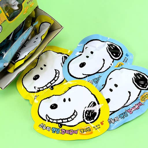 Snoopy-themed face packages on a green background