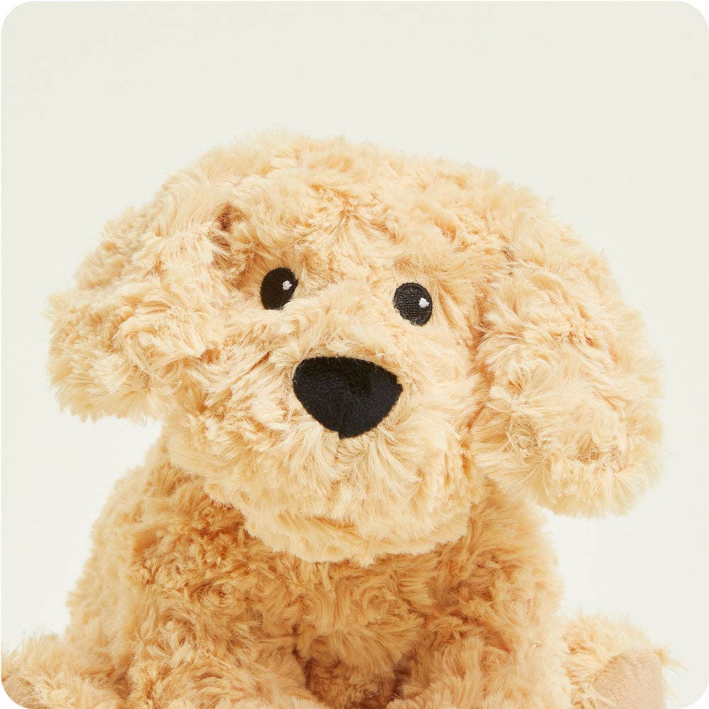 Plush toy dog with a light brown fur and black nose on a white background