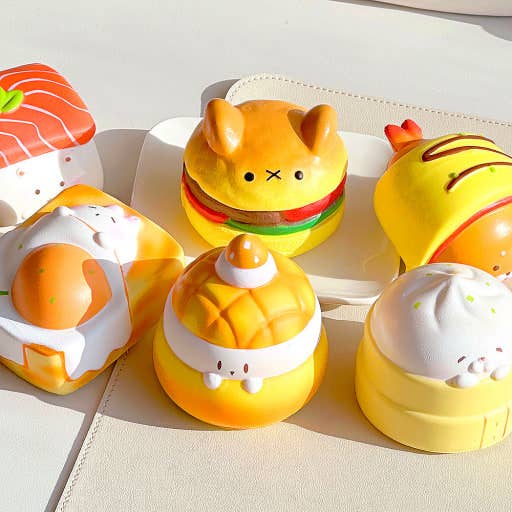Set of cute food-themed toys on a light background