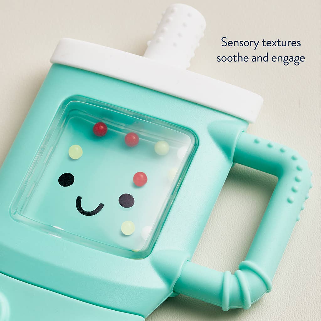 Teal baby teether with a smiley face design on a beige background