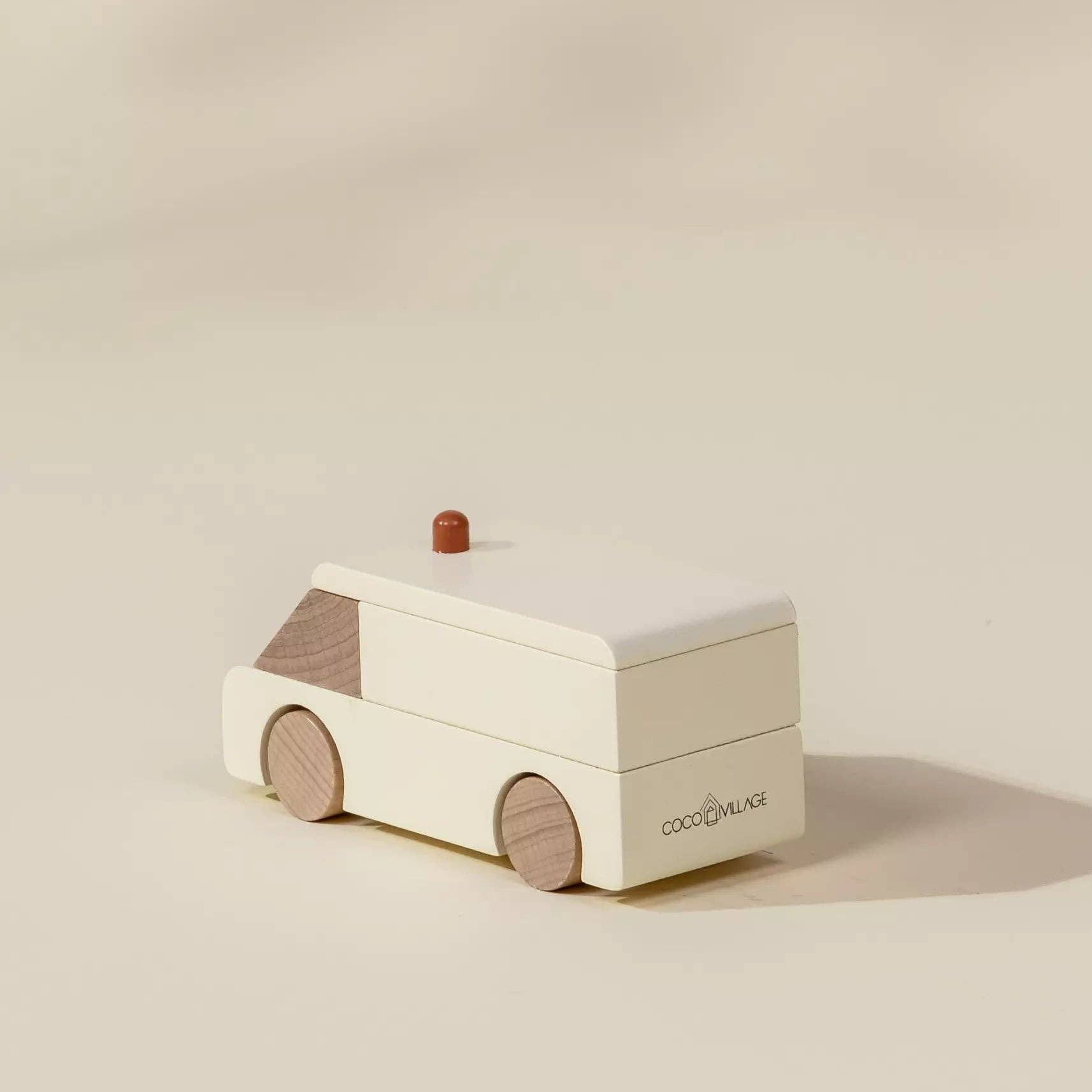 Wooden toy car with a red roof on a beige background