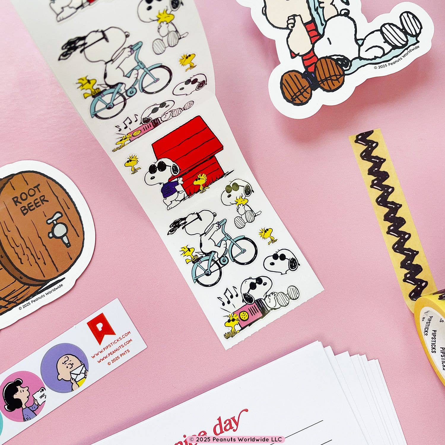 Collection of Peanuts-themed stickers on a pink background