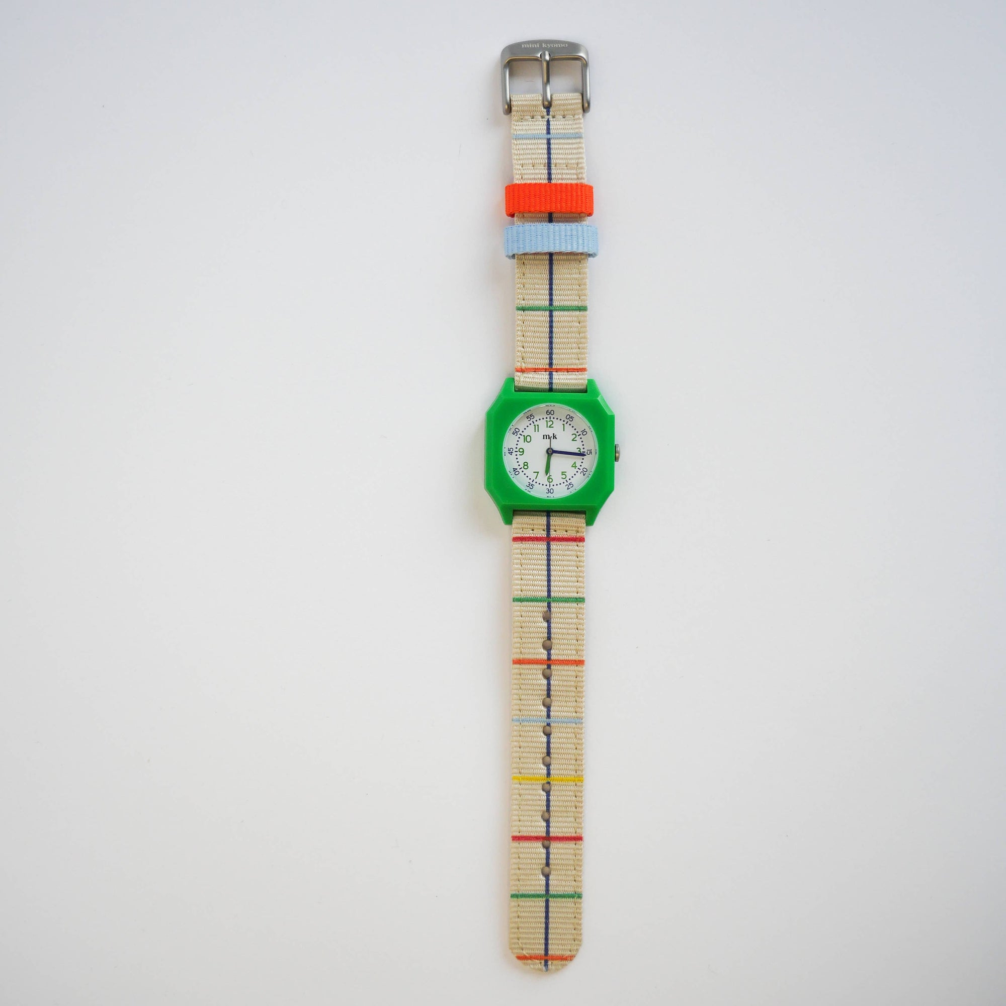 Wristwatch with a colorful plaid strap on a white background