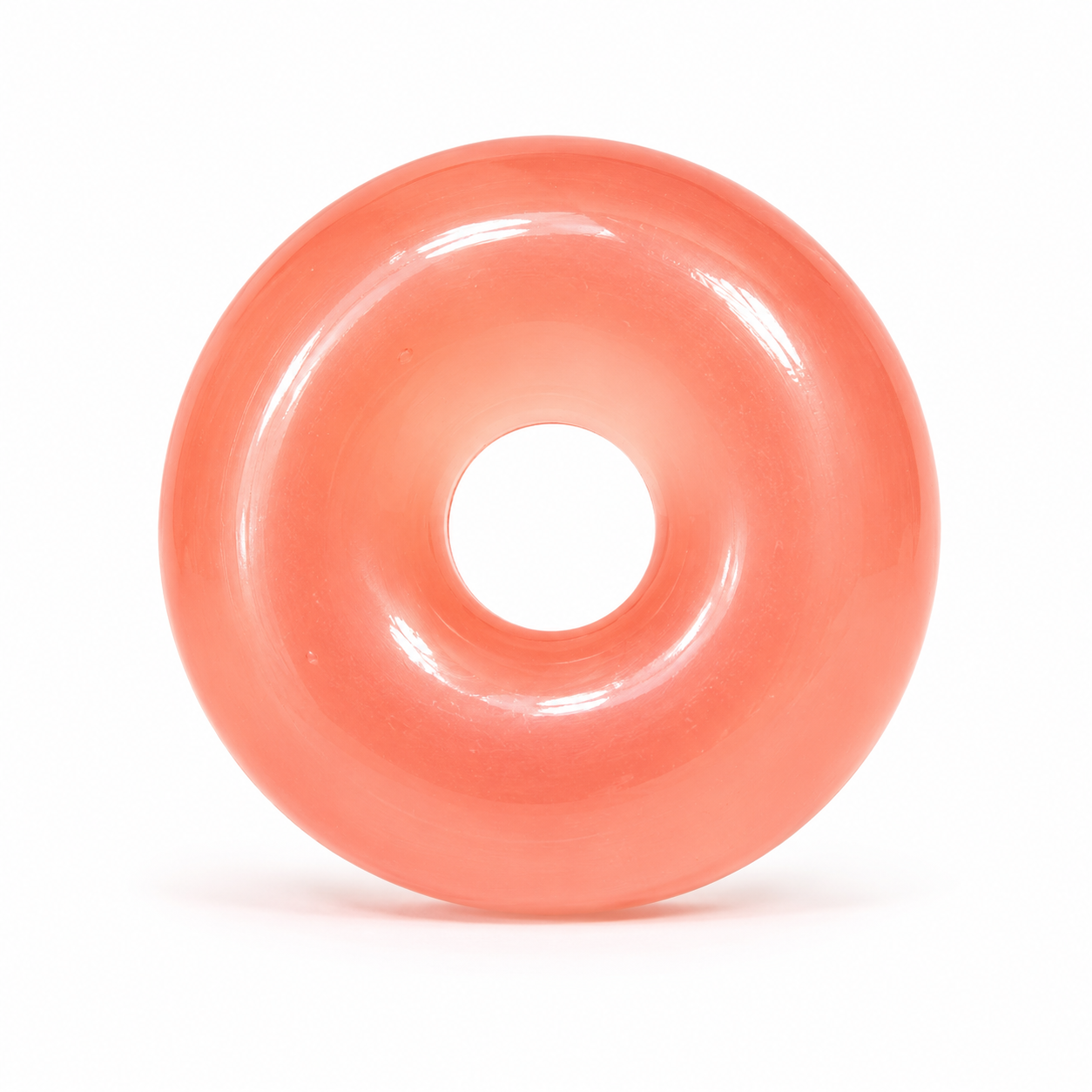 Pink donut-shaped object on a white background