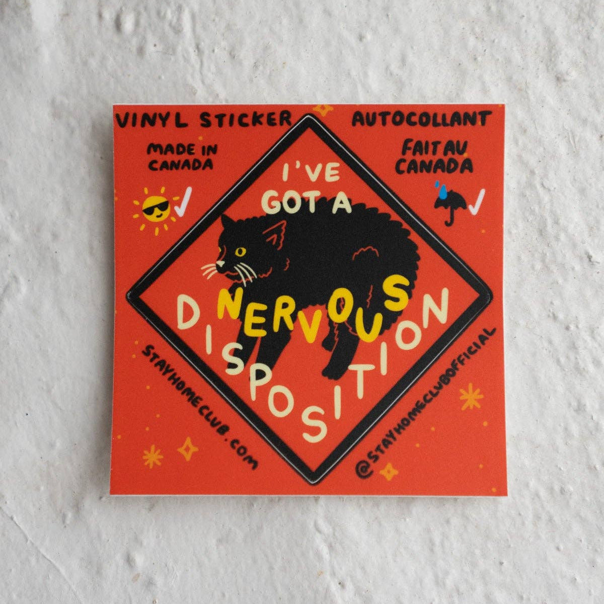 Vinyl sticker with a black cat design and text on a textured white background