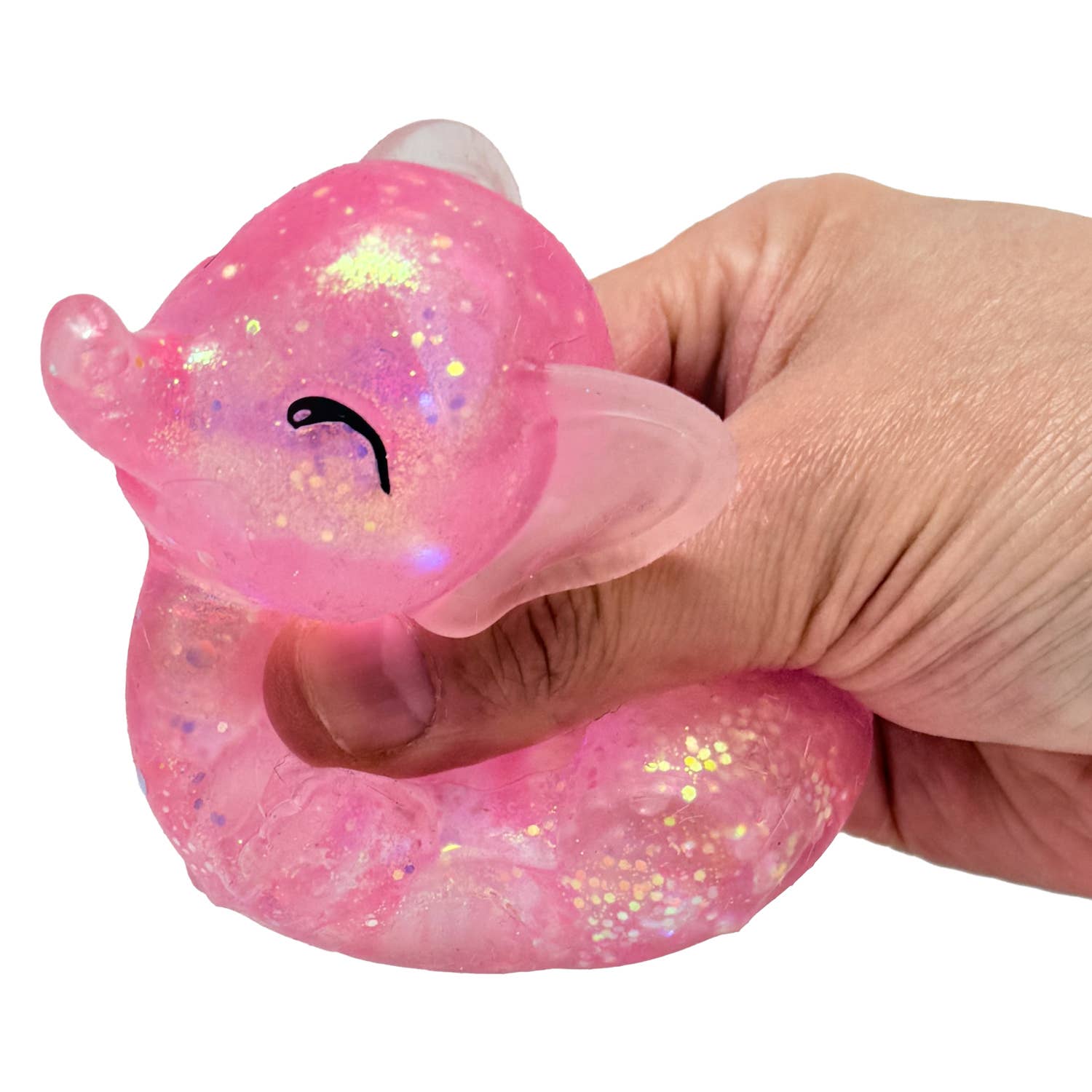 Hand holding a pink glittery duck-shaped object against a white background