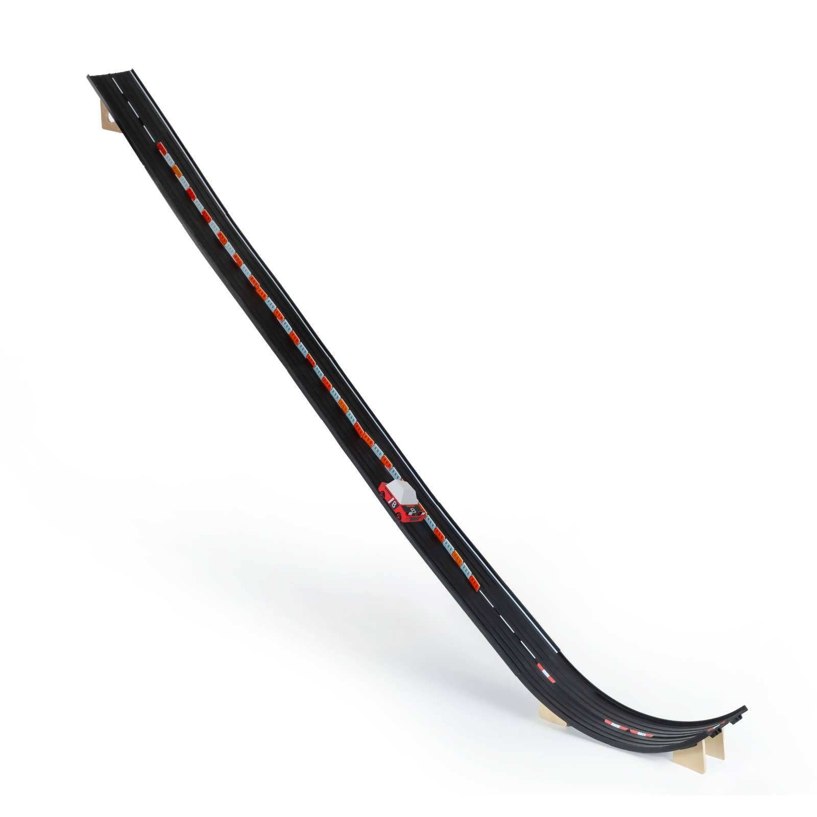 Black toy track with a small car on a white background