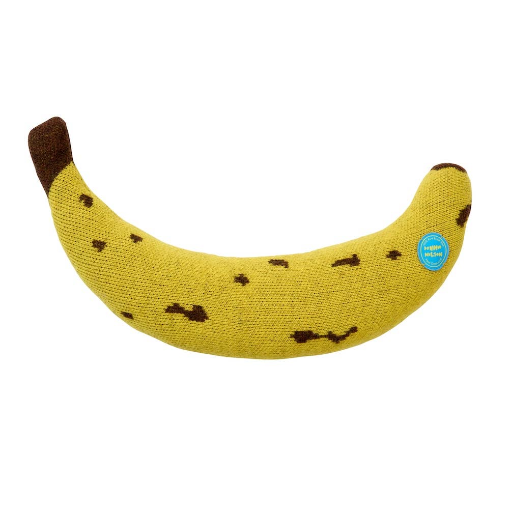 Knitted banana-shaped cushion with a brown stem on a white background
