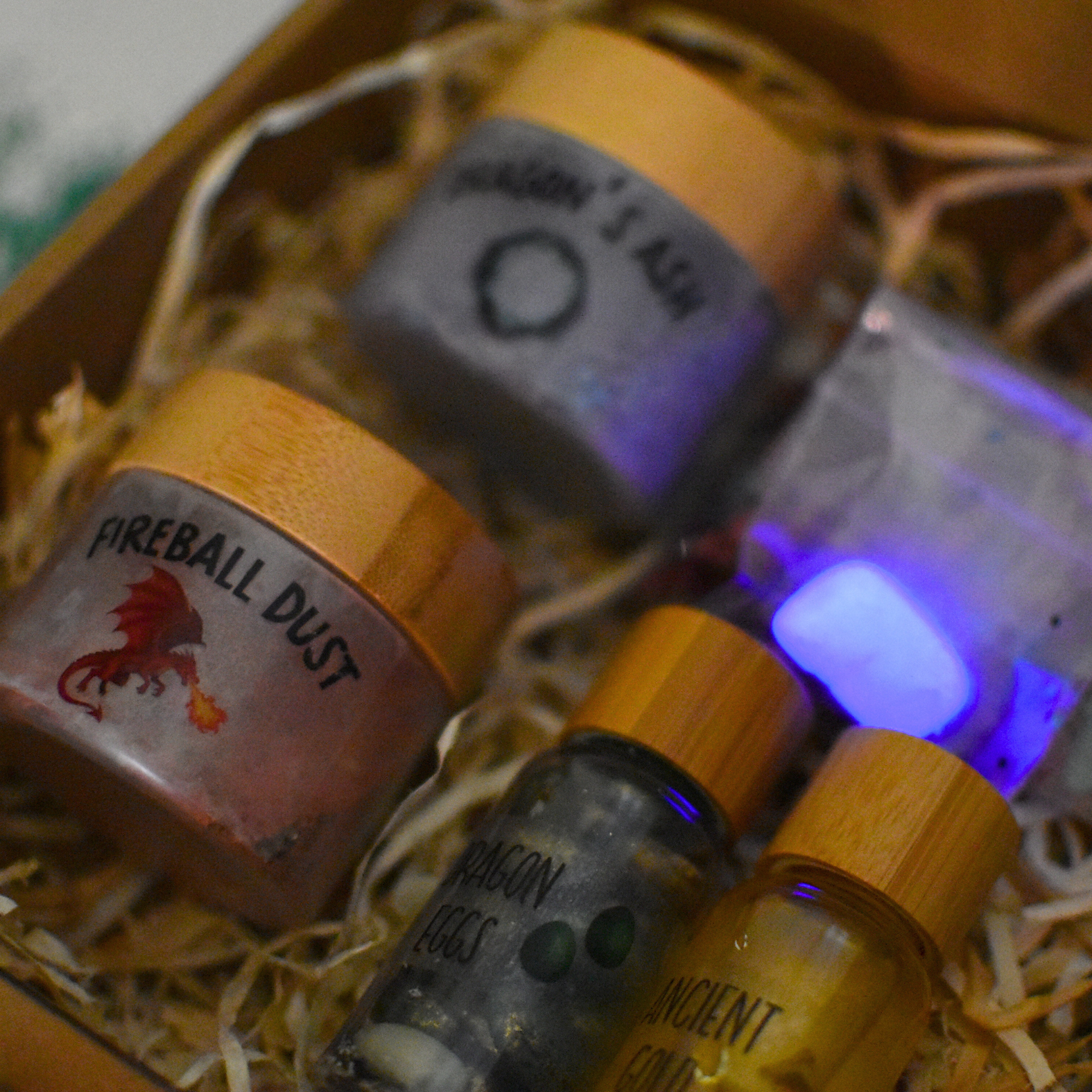 Collection of small bottles with labels in a decorative box