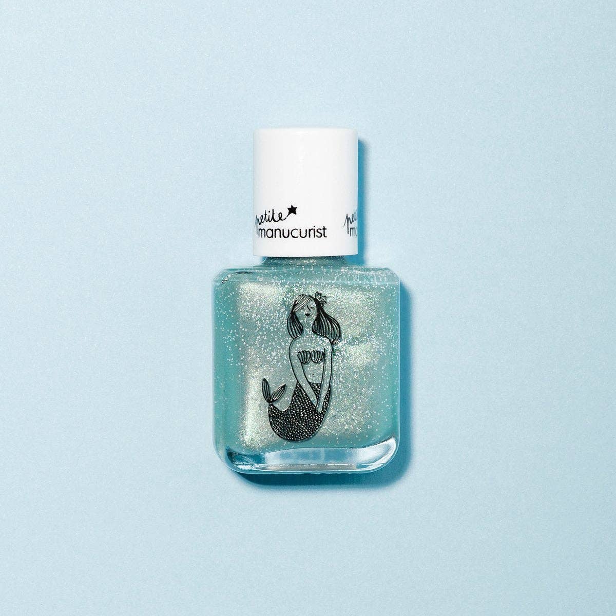 Blue glittery nail polish bottle with a mermaid design on a light blue background