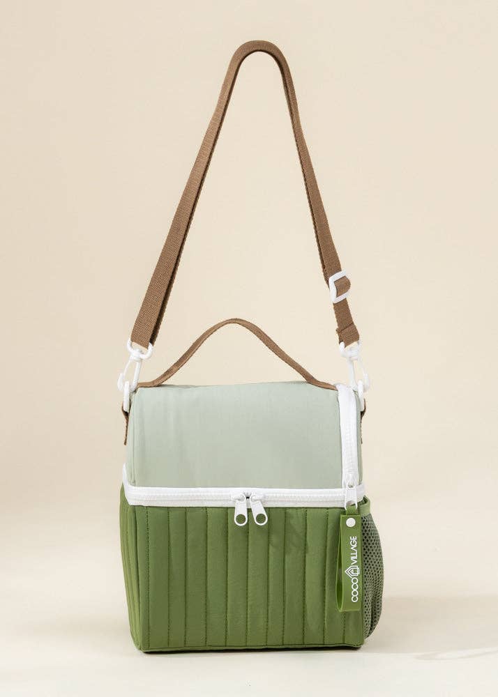 Green lunchbox bag with brown strap on a beige background