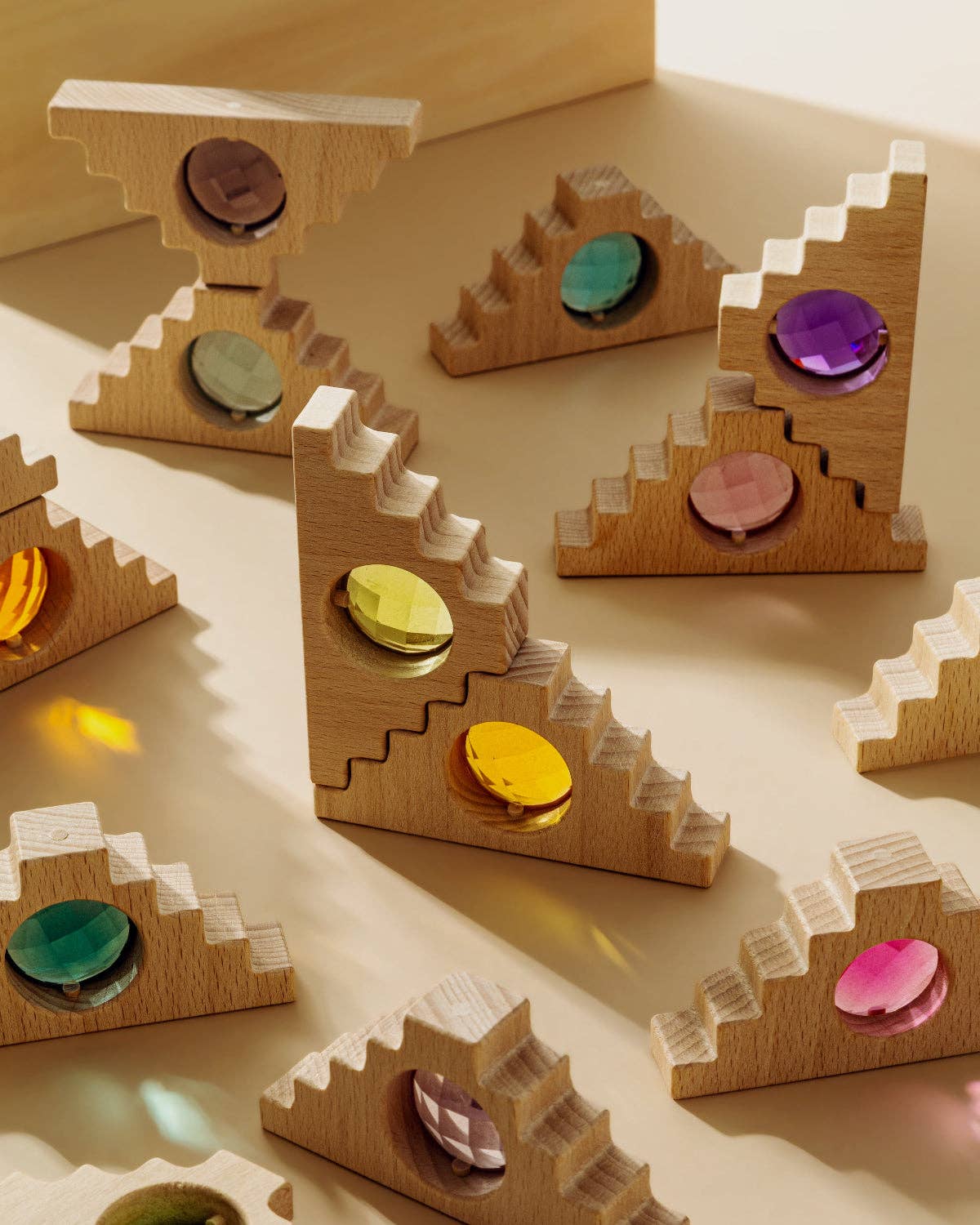 Wooden puzzle toy with colorful stones on a beige surface