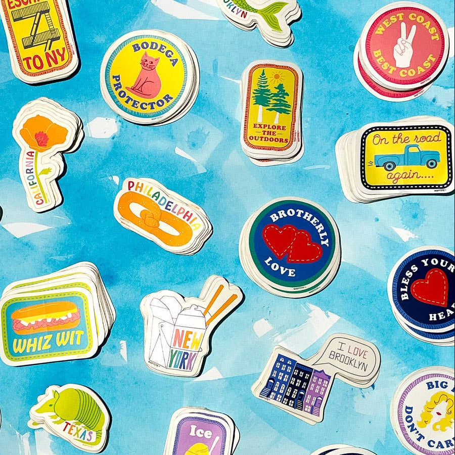 Collection of colorful stickers with various designs on a blue background