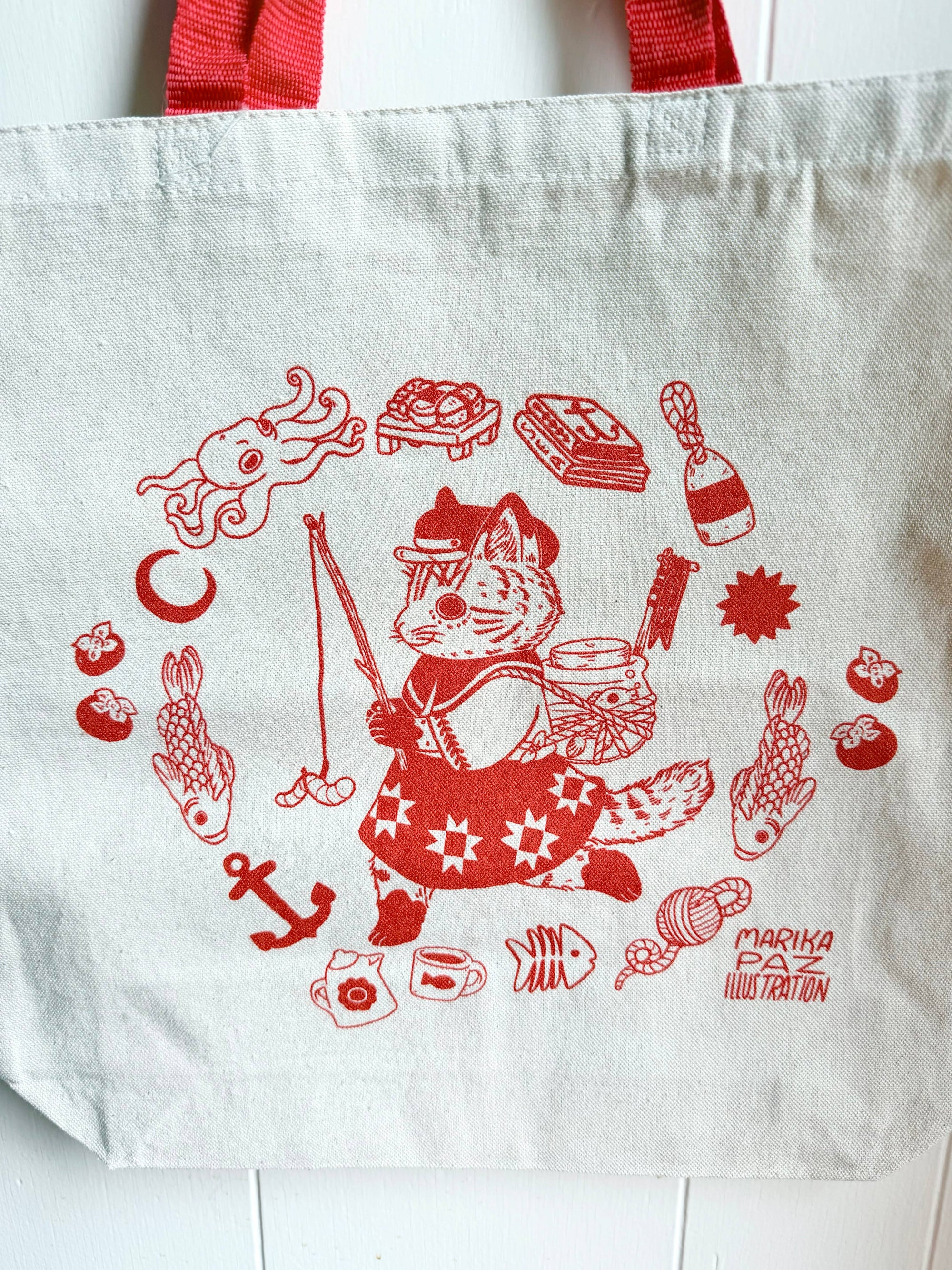 White tote bag with red fox illustration and various symbols on a white background