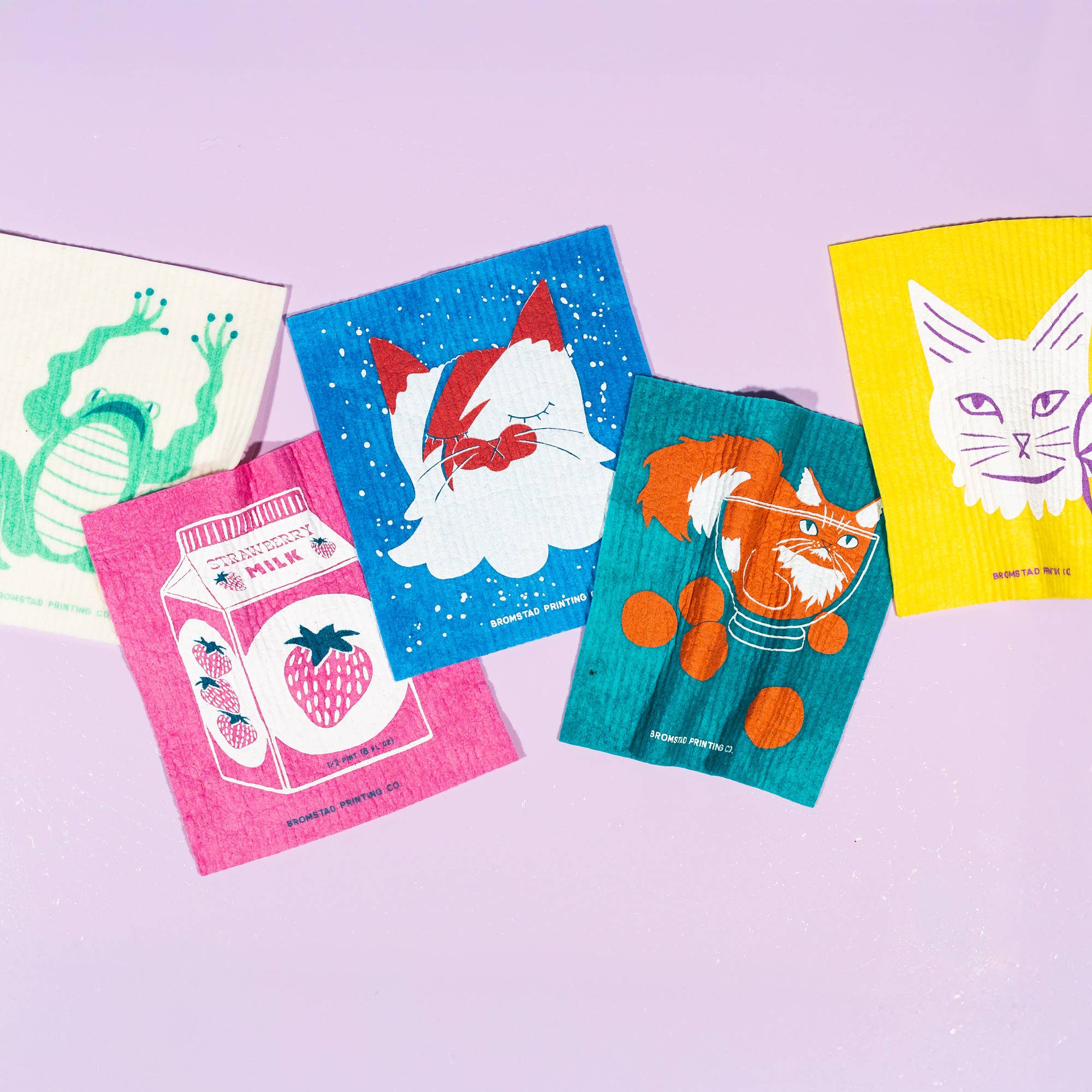 Colorful cat-themed napkins on a light purple background
