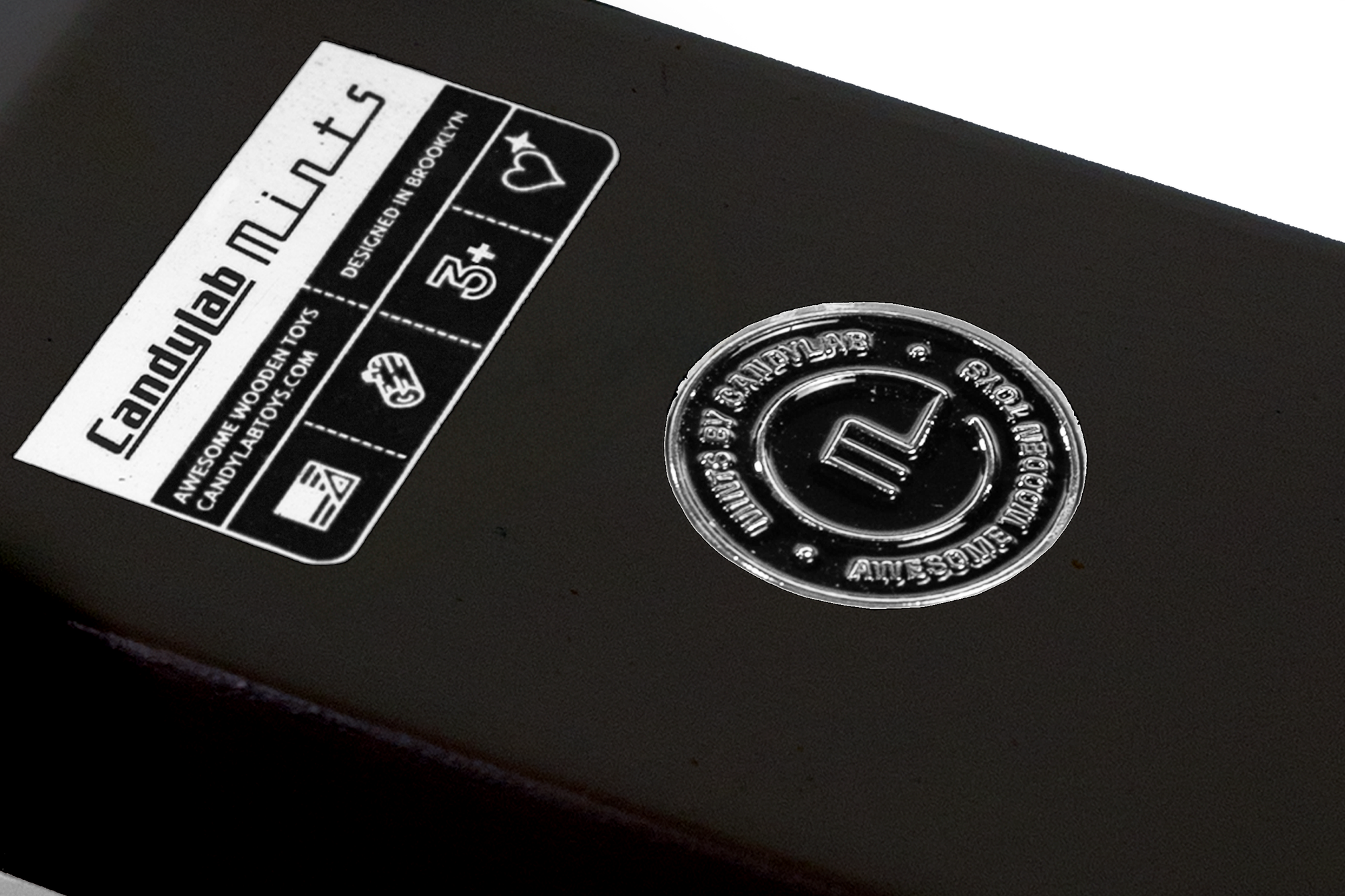 Close-up of a black product with 'CandyLab Mills' branding and logo.