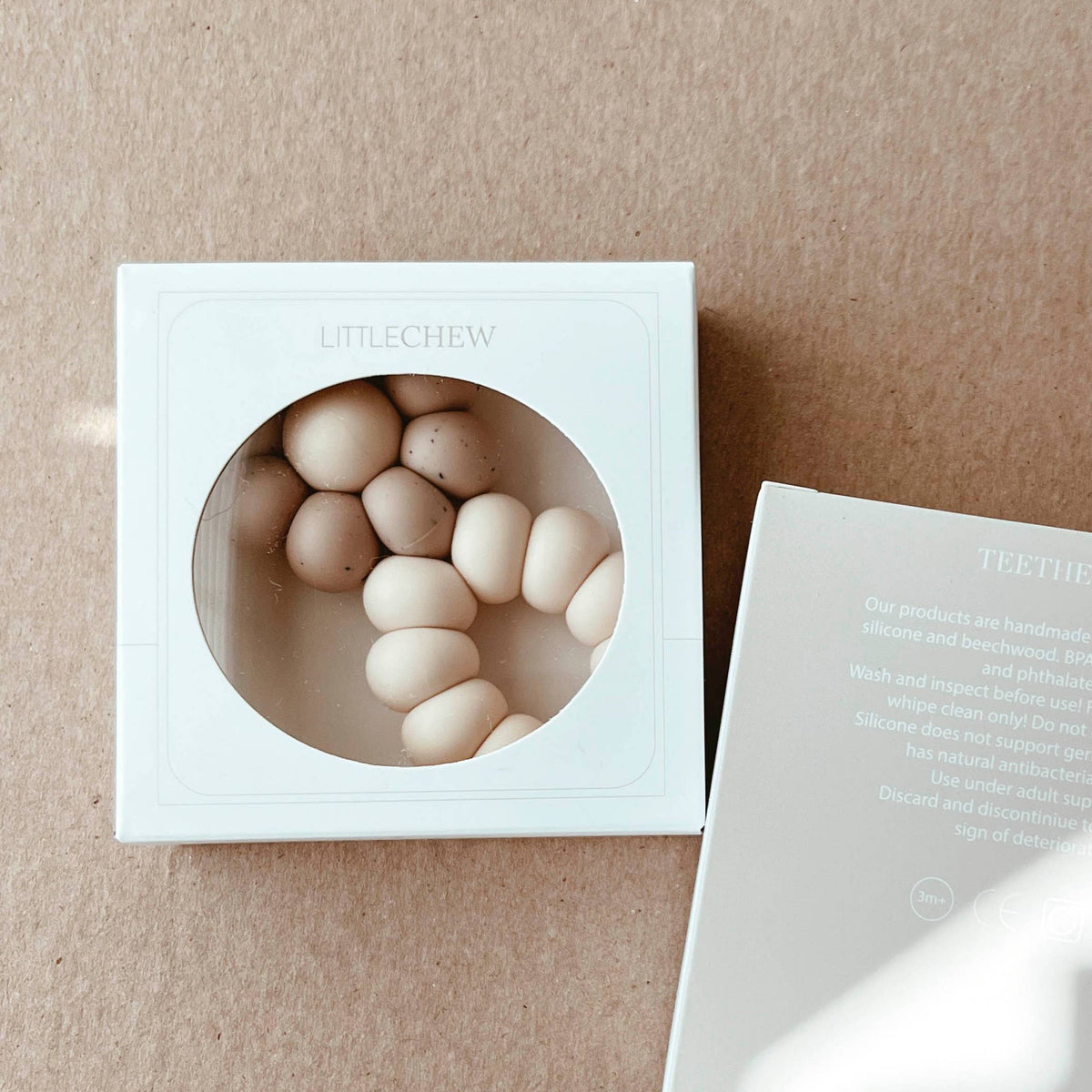 White box with round objects on a beige background